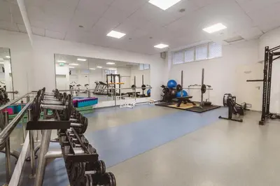 a gym with rows of tread machines in a room at Hotel Kompas in Kranjska Gora