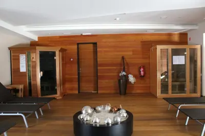 a lobby with chairs and a table in a room at Hotel Alpina in Kranjska Gora