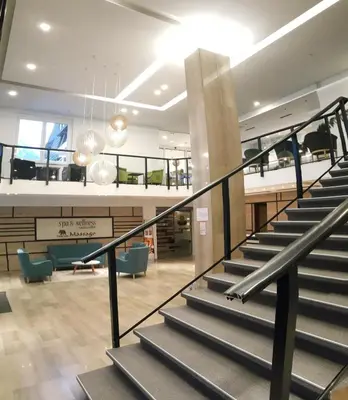 a staircase in a building with a lobby at Hotel Alpina in Kranjska Gora