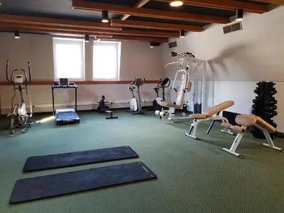 a gym with several treadmills and exercise machines at Hotel Alpina in Kranjska Gora