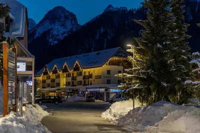 a resort with a christmas tree in the snow at Vitranc Apartments in Kranjska Gora