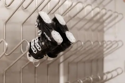 a group of baseball gloves hanging on a rack at Apartments Rozle in Kranjska Gora