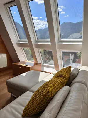 a room with a couch with corn on it with windows at Apartments Kaninska Vas in Bovec