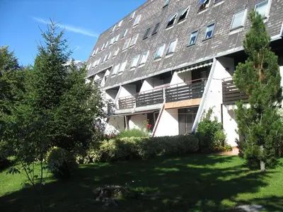 an apartment building with a lawn in front of it at Apartments Kaninska Vas in Bovec