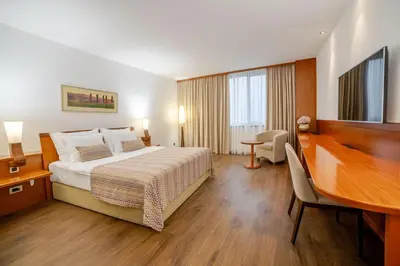 a hotel room with a bed and a desk at Perla, Resort & Entertainment in Nova Gorica
