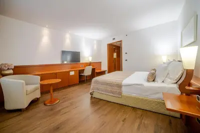 a hotel room with a bed and a tv at Perla, Resort & Entertainment in Nova Gorica