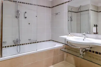 a bathroom with a tub and a sink and a shower at Perla, Resort & Entertainment in Nova Gorica
