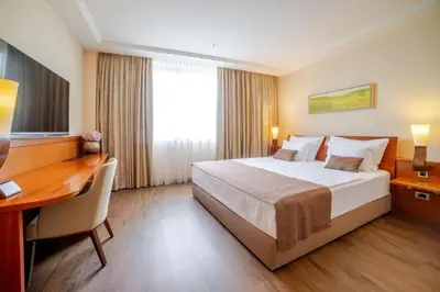a hotel room with a bed and a desk at Perla, Resort & Entertainment in Nova Gorica