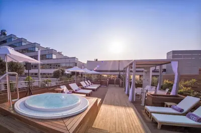 a rooftop pool with chairs and a hot tub at Perla, Resort & Entertainment in Nova Gorica