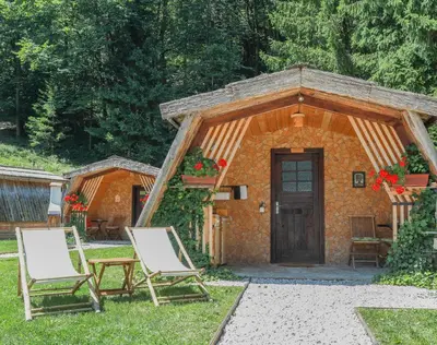a couple of chairs sitting in front of a cabin at Penzion Pibernik in Bled