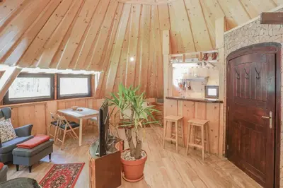 a living room with wooden walls and a wooden ceiling at Penzion Pibernik in Bled