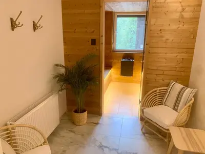 a hallway with chairs and a table and a plant at Penzion Pibernik in Bled
