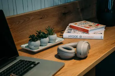 a desk with a laptop computer and books on it at Guest House Pohorska Kavarna in Maribor