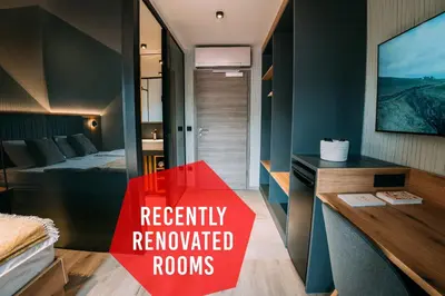 a room with a red sign that reads recently renovated rooms at Guest House Pohorska Kavarna in Maribor