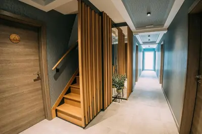 a hallway with wooden stairs in a building at Guest House Pohorska Kavarna in Maribor