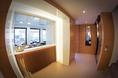 a hallway of a building with a window and a bathroom at Guest House Pohorska Kavarna in Maribor