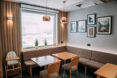 a waiting room with a bench and a table at Guest House Pohorska Kavarna in Maribor