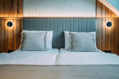two beds sitting next to each other in a bedroom at Guest House Pohorska Kavarna in Maribor