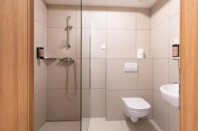 a bathroom with a shower and a toilet and a sink at Grajski Dvor in Radovljica