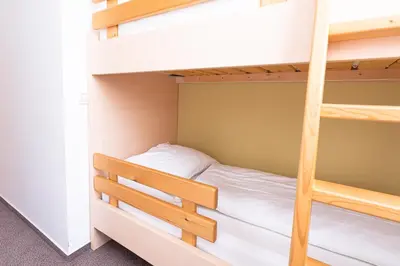 a bedroom with bunk beds in a dorm room at Grajski Dvor in Radovljica