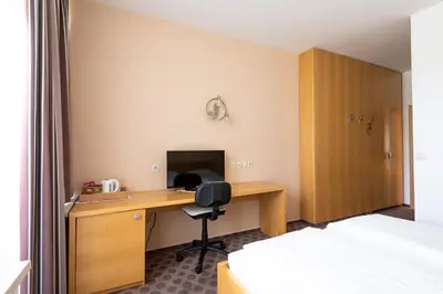 a hotel room with a desk and a computer at Grajski Dvor in Radovljica