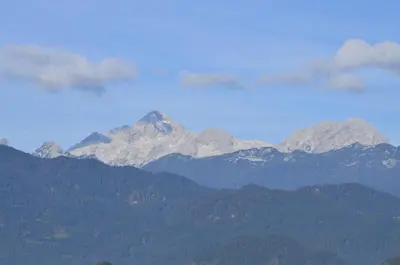 a mountain in the distance with snow capped mountains at Grajski Dvor in Radovljica