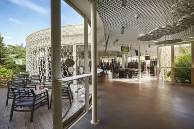 a room with chairs and tables in a building at Park, Hotel & Entertainment in Nova Gorica