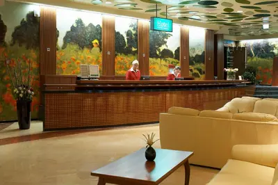 a lobby with a waiting area with two women at a reception counter at Park, Hotel & Entertainment in Nova Gorica
