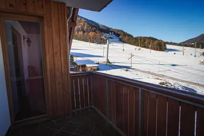 a balcony with a view of a snow covered field at Apartments Telemark Kranjska Gora in Kranjska Gora