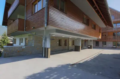 a large building with a courtyard in front of it at Apartments Telemark Kranjska Gora in Kranjska Gora