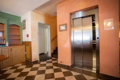 an elevator in a room with a checkered floor at Apartments Telemark Kranjska Gora in Kranjska Gora