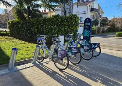 three bikes parked in a rack on a sidewalk at Sabotin, Hotel & Restaurant in Nova Gorica