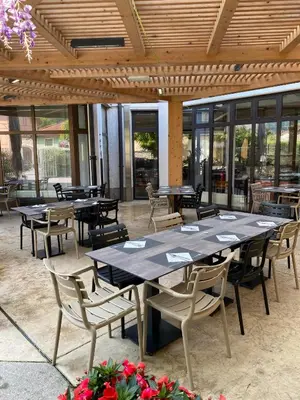 a group of tables and chairs in a restaurant at Sabotin, Hotel & Restaurant in Nova Gorica