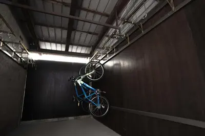 a bike hanging from a wall in a tunnel at Sabotin, Hotel & Restaurant in Nova Gorica