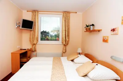 a bedroom with a bed and a window at Guest House Pri Gondoli in Maribor