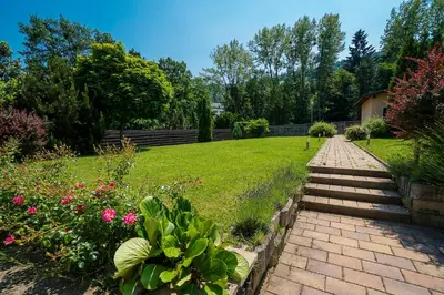 a brick path leading to a garden with flowers at Guest House Pri Gondoli in Maribor