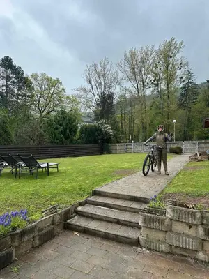 a person standing with a bike on a path at Guest House Pri Gondoli in Maribor