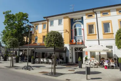 a group of people sitting outside of a building at Lipa, Hotel & Bistro in Nova Gorica
