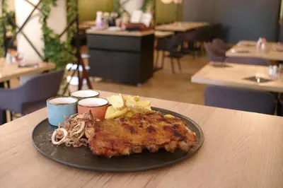 a plate of food on a table in a restaurant at Lipa, Hotel & Bistro in Nova Gorica
