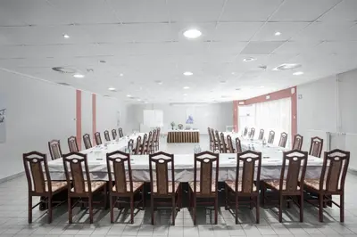 a conference room with a long table and chairs at Lipa, Hotel & Bistro in Nova Gorica