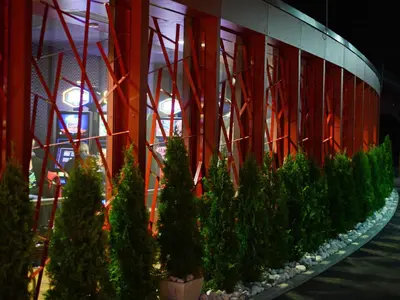 a row of christmas trees in front of a building at Korona, Resort & Entertainment in Kranjska Gora