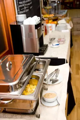 a buffet line in a restaurant with food at Hotel Faraon in Celje