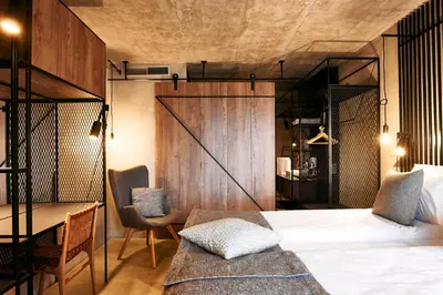 a bedroom with a bed and a desk and a bed sidx sidx sidx at Hotel Maestoso - Lipica in Sežana
