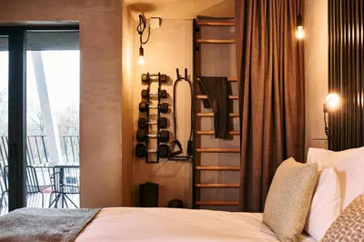 a bedroom with a bed and a balcony at Hotel Maestoso - Lipica in Sežana