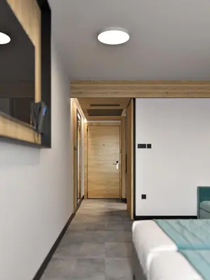 a bedroom with a bed and a wooden door at Hotel Zdravilisce - Thermana Lasko in Laško