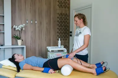 a woman in a hospital room with a patient at Hotel Zdravilisce - Thermana Lasko in Laško