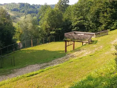 a bench in a field next to a fence at Brunarica in Globoko