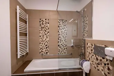 a bath tub in a bathroom with a window at Guesthouse Stari Mayr in Kranj