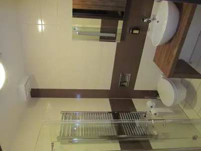 a bathroom with a toilet and a sink and a mirror at Hotel Opara in Trebnje