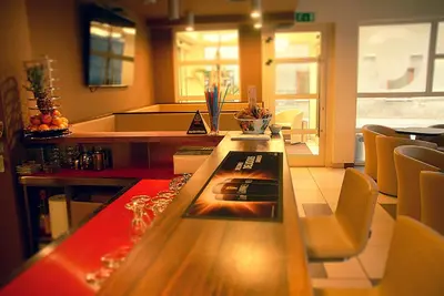 a kitchen with a table and chairs in a room at Hotel Opara in Trebnje